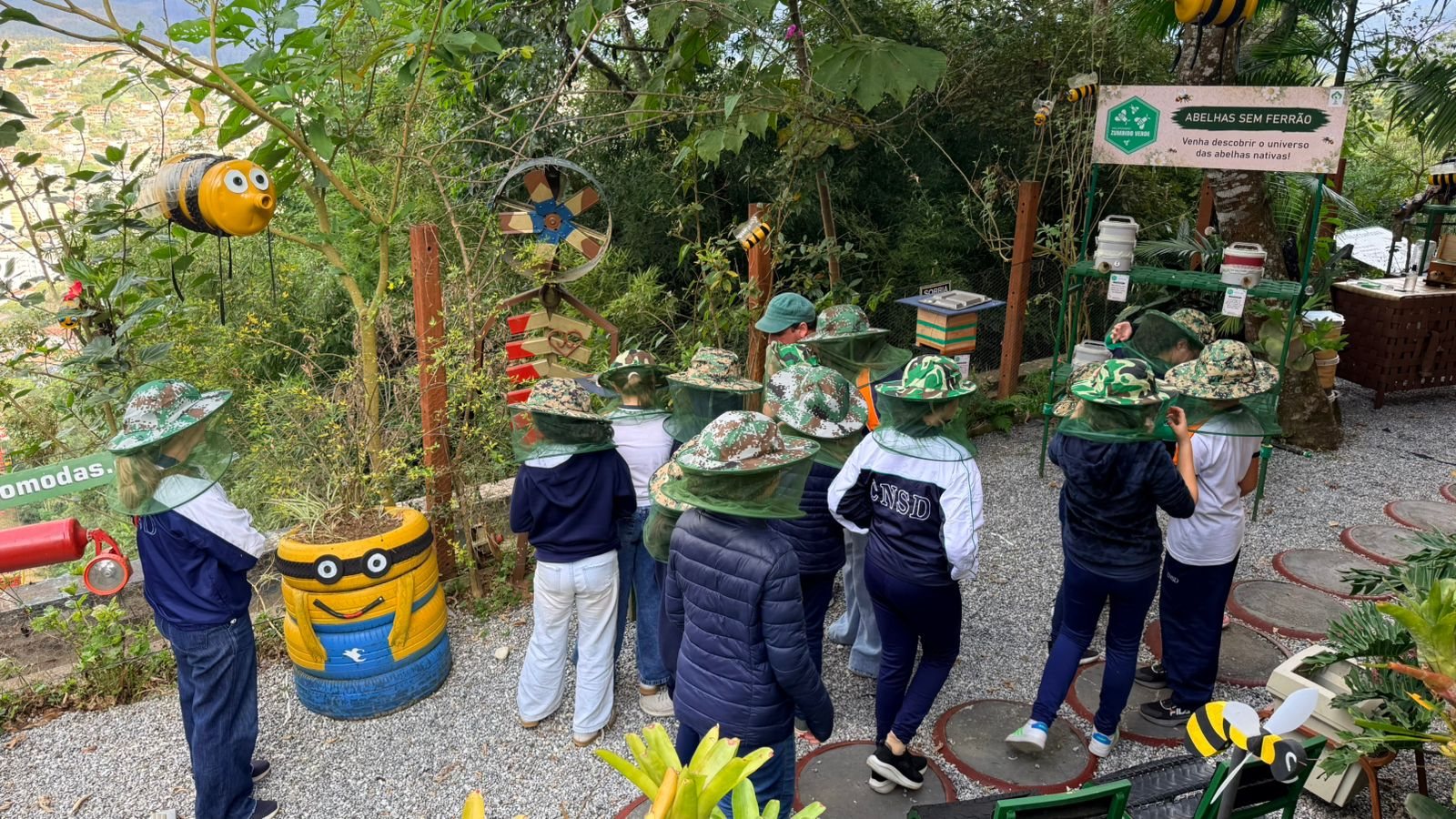 Turma de chapéu de apicultor no meliponário